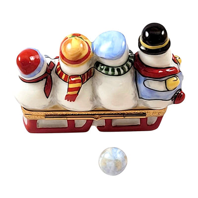 Three cheerful snowmen riding on a colorful sled through the snowscape
