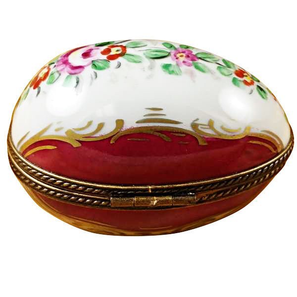 Burgundy egg with intricate floral design and gold accents 