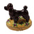 Chocolate-Poodle-dog-stuffed-animal-sitting-on-a-pillow 
