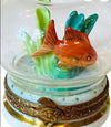 Tiny-gold-fish-in-a-round-glass-bowl-with-rippled-surface
