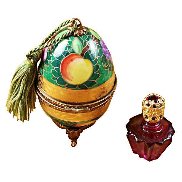 Green and gold hand-painted egg with intricate designs and one bottle of matching color 