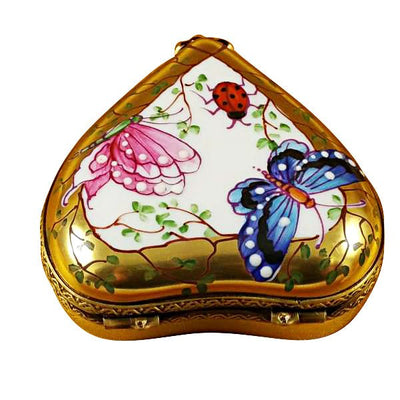 Exquisite and beautiful heart-shaped butterfly figurine displayed on a shimmering gold stand