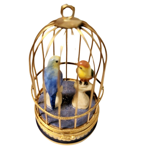 Parakeets playing with toys in a spacious metal cage 