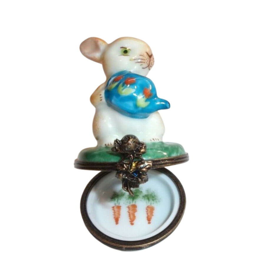 Rabbit figurine holding a watering can in front of La Gloriette 