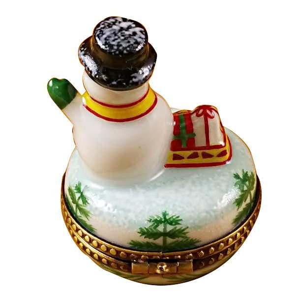 Small-snowman-figurine-crafted-from-white-marble-with-red-and-green-hat 