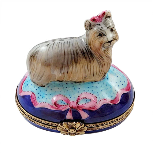 Terrier dog figurine with brown coat and floppy ears on blue base 