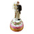 Wedding couple figurines standing on top of a white wedding cake 