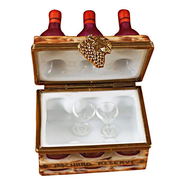 Wine bottles in wooden crate with two wine glasses 