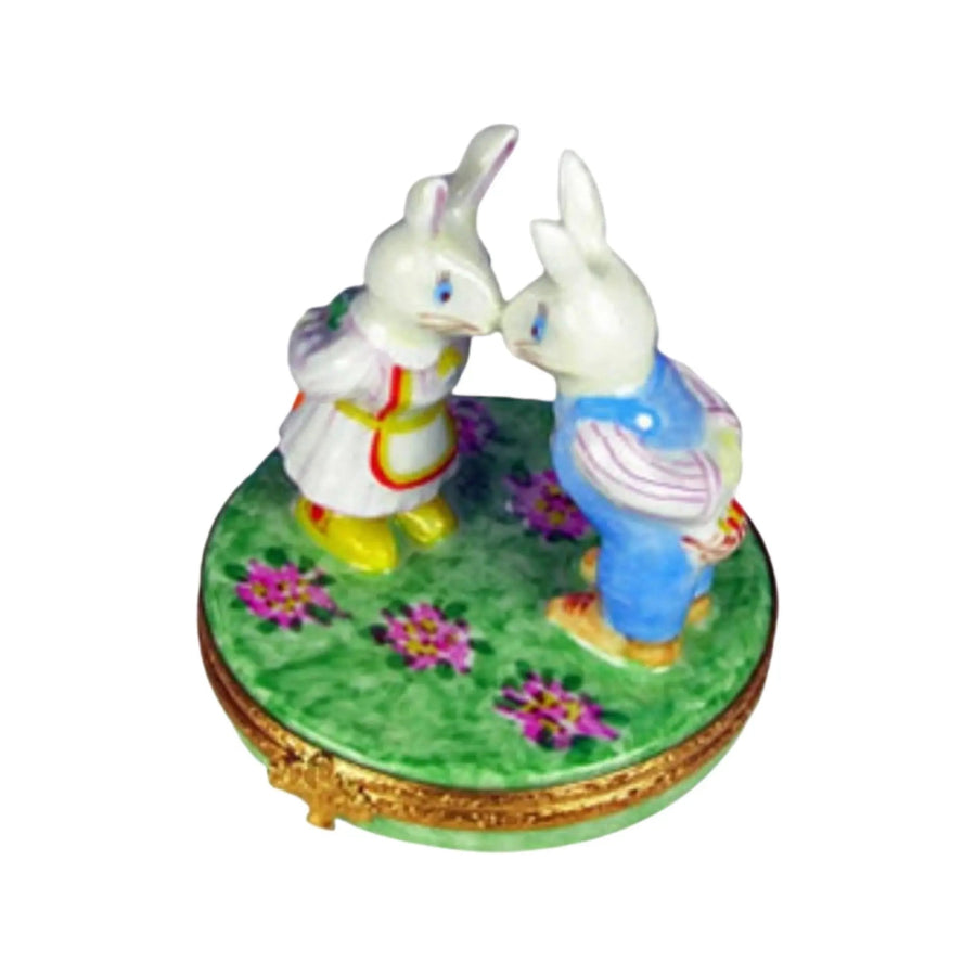 Adorable Mr and Mrs Rabbit plush toys holding hands in a garden