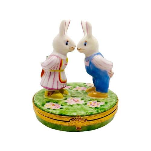 Adorable Mr and Mrs Rabbit plush toys holding hands in a garden
