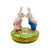 Adorable Mr and Mrs Rabbit plush toys holding hands in a garden
