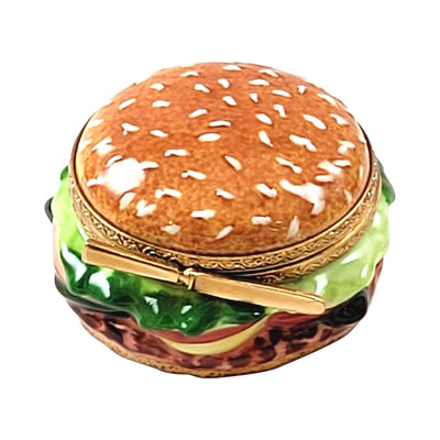 Delicious juicy hamburger with lettuce, cheese, and tomato on a sesame seed bun