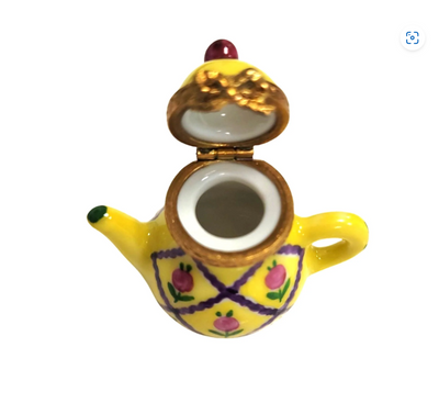Close-up of the elegant yellow teapot with a shiny glaze finish