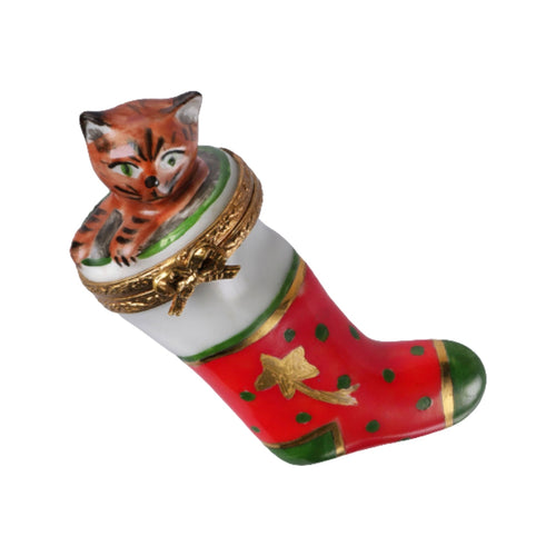 Christmas stocking with adorable kitten playing with a snowflake toy 