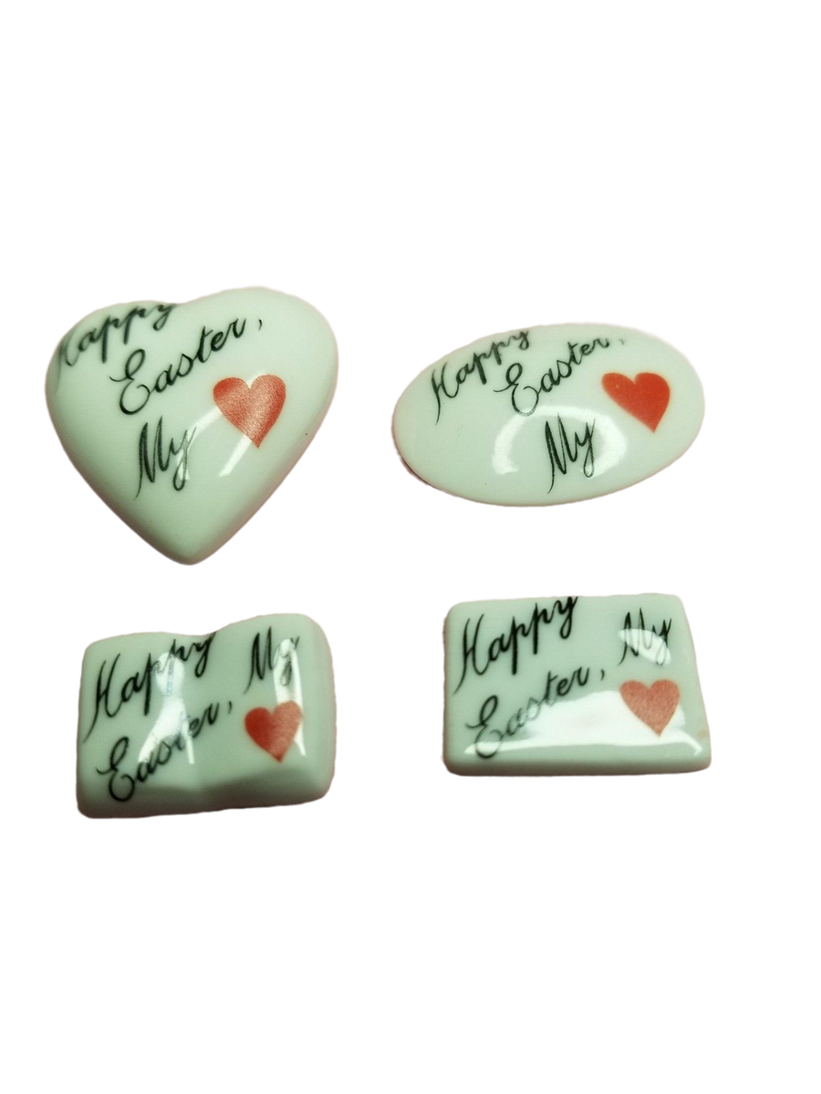 Colorful chocolate Easter eggs arranged in a heart shape with a tag that says 'Happy EASTER My Love - Goodie'