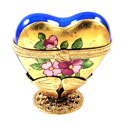 Exquisite blue-gold heart-shaped glass displayed on an elegant brass butterfly stand