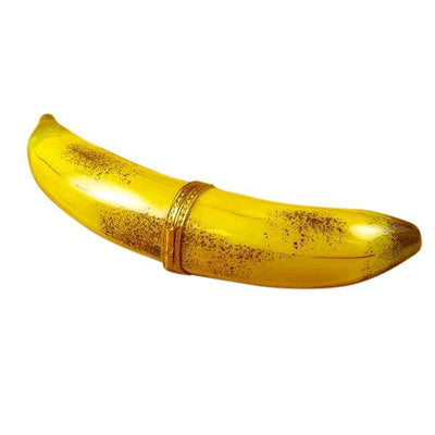 Ripe yellow banana with brown spots and green stem
