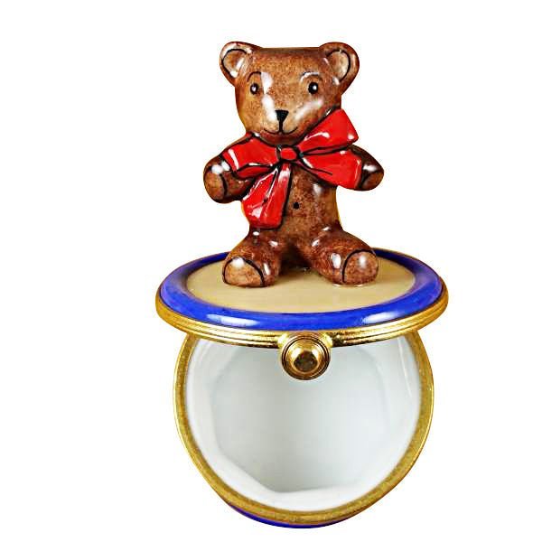 Cute-brown-bear-stuffed-animal-on-top-of-red-drum