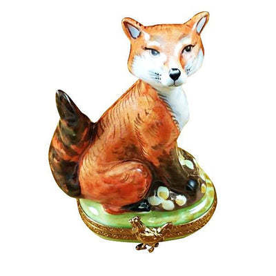 Fox running through a green meadow with its fluffy tail raised high