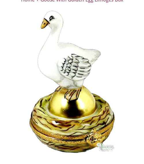 Beautiful golden goose with a shiny, golden egg in a nest