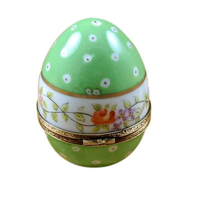 A decorative green egg adorned with blooming flowers and greenery