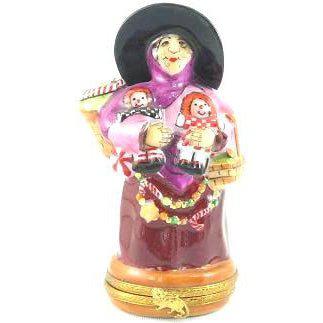 Handcrafted Lynn Haney Gumdrop Witch doll, wearing a festive outfit and holding a broomstick