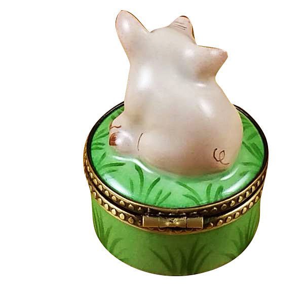 Handcrafted miniature pig ornament on vibrant green stand