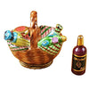A wicker picnic basket with a wine bottle and glasses