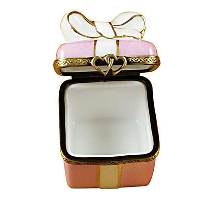 Beautifully wrapped present in pink with shiny gold bow