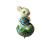 Rabbit figurine holding a watering can in front of La Gloriette