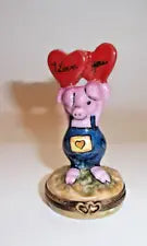 A ceramic figurine of a cute pig with the words I Love You painted on its belly