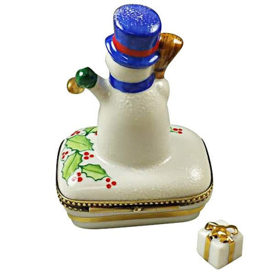 Cute snowman figurine with a blue scarf and twig arms