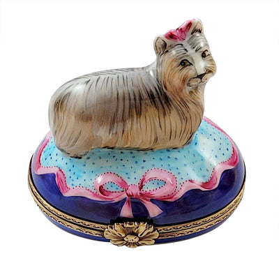 Terrier dog figurine with brown coat and floppy ears on blue base