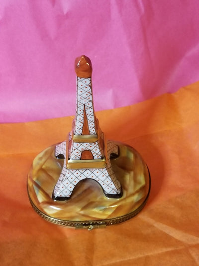 Miniature white Eiffel Tower sculpture showcased on a brown base