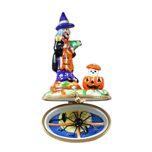 Halloween-themed witch figurine with a jack-o-lantern accessory